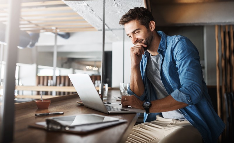 An entrepreneur checks his business savings account online.